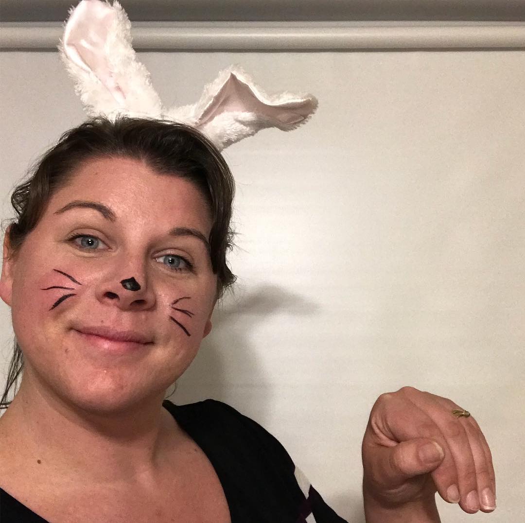 Smiling woman dressed as easter rabbit