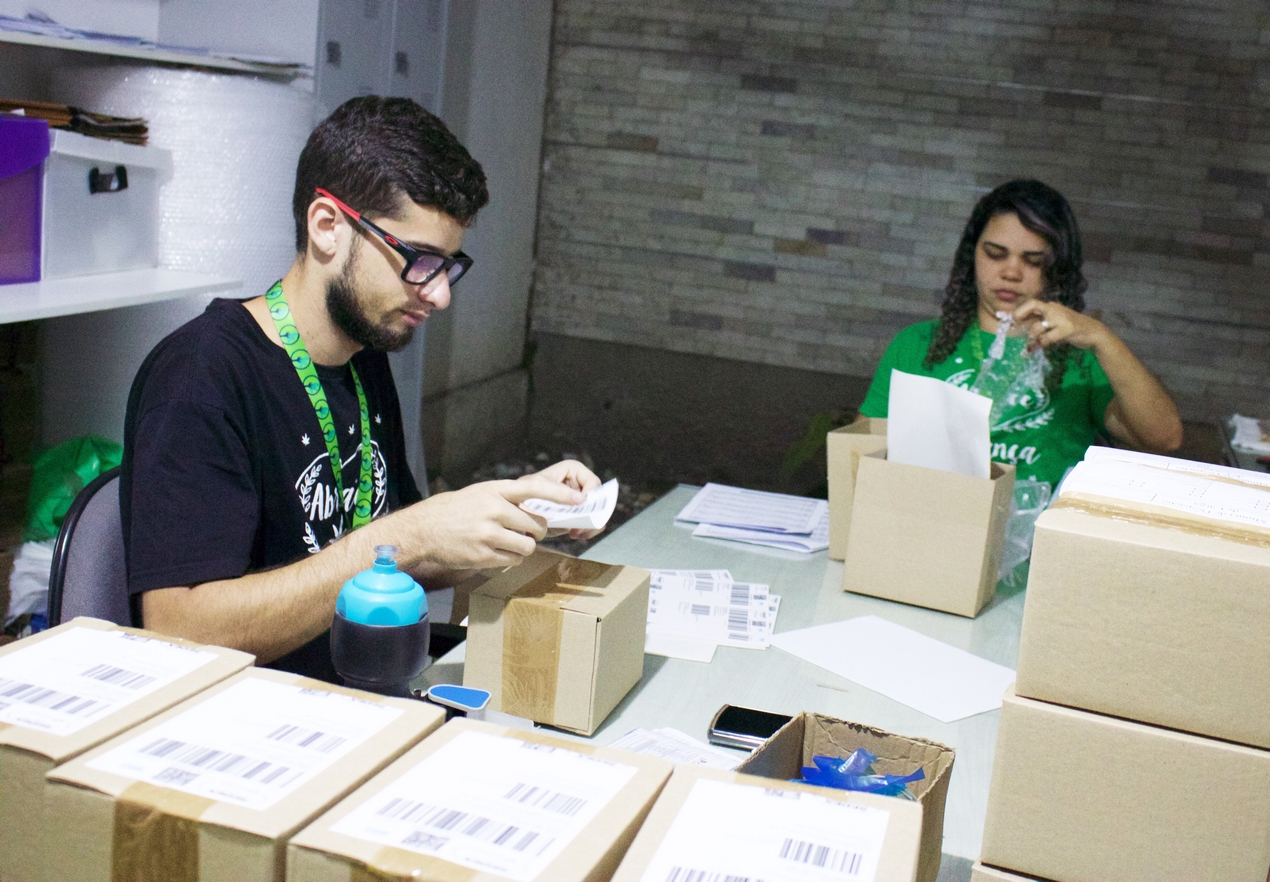 medical marijuana workers packing boxes in Brazil