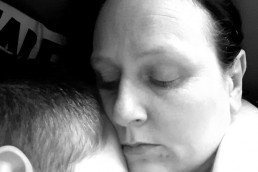 Black and white photo of British mother holding her epileptic son
